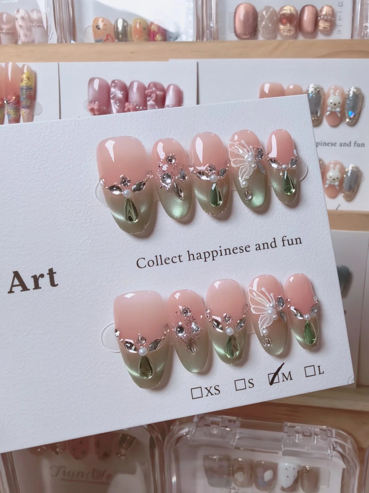Handmade pink and green gradient press-on nails with crystals and pearl decorations