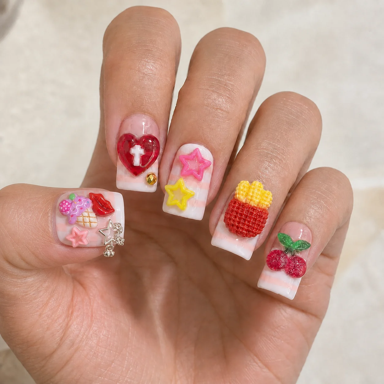 Model wearing Festival Candy Charm press-on nails, long square