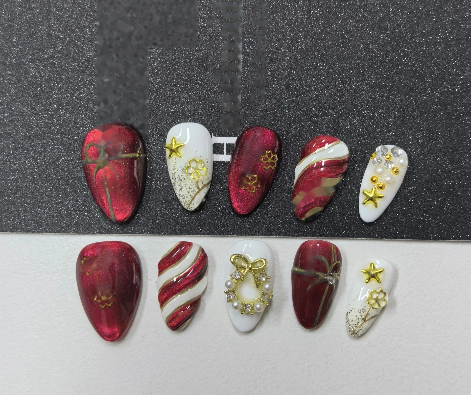 Christmas Candy Cane Red Press-On Nails — red-to-white candy-cane stripes, gold star and wreath charms on a glossy red base