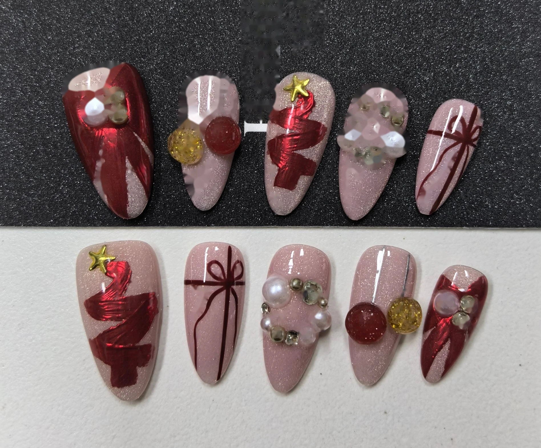 Christmas Gift Bow Pink Press-On Nails — red ribbon bows, pearl accents and gift-box charms on a soft pink base
