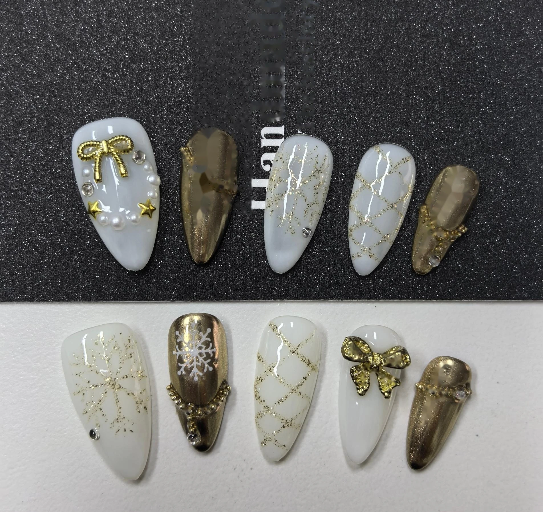 Christmas Gold Bow Chrome Press-On Nails — gold bow charms, chrome and lattice-texture accents on a creamy white base