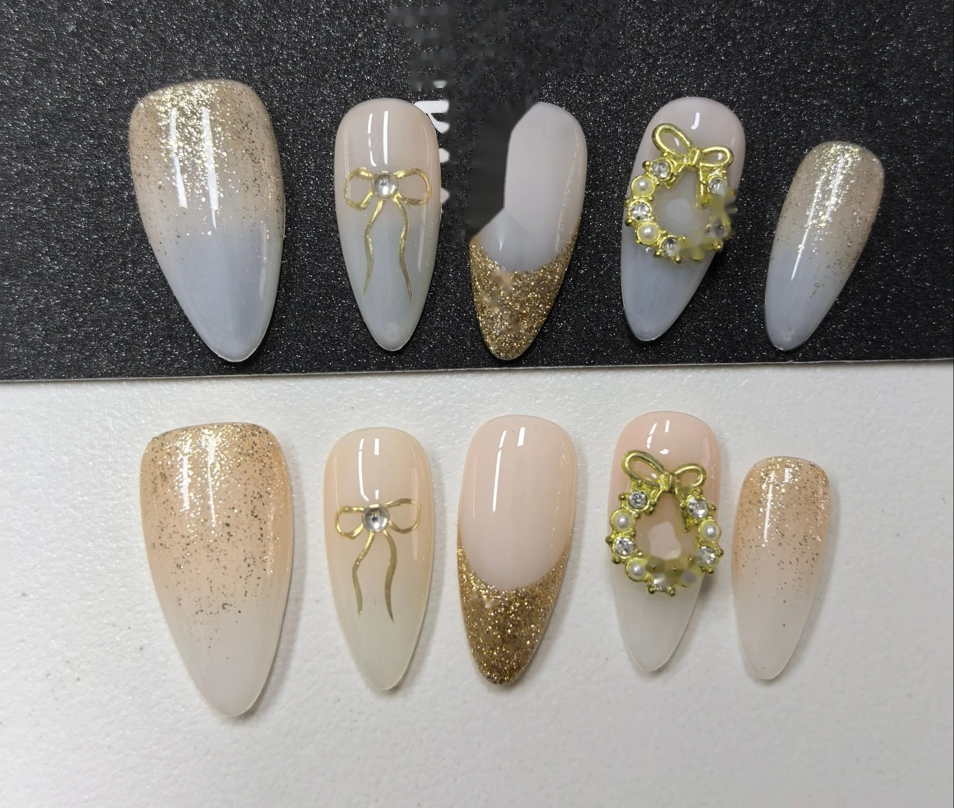 Christmas Gold Wreath Press-On Nails — gold wreath charms, bow accents and a glitter gold fade on a nude base