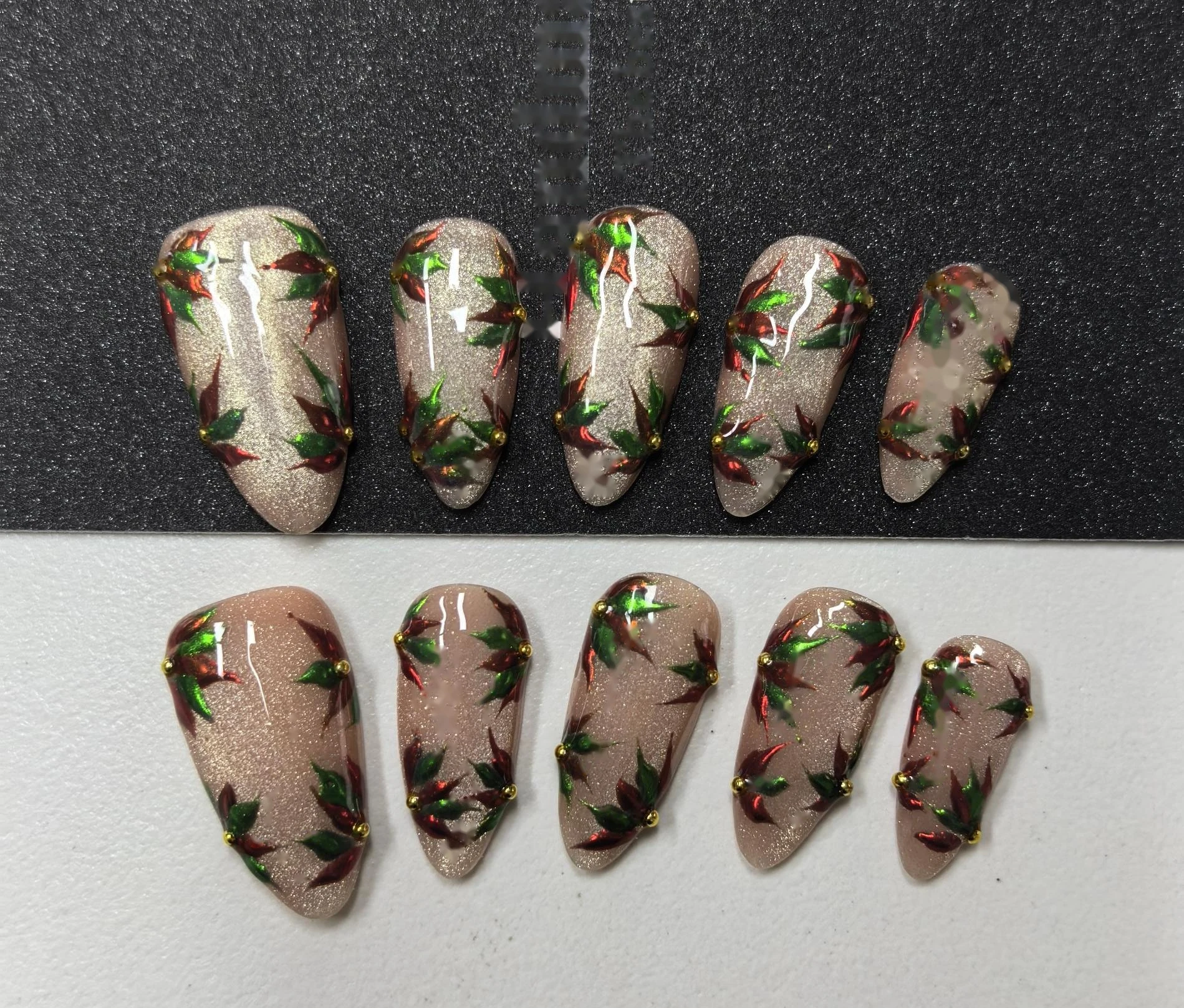 Christmas Holly Print Press-On Nails — all-over holly wreath prints with green leaves on a shimmering nude base